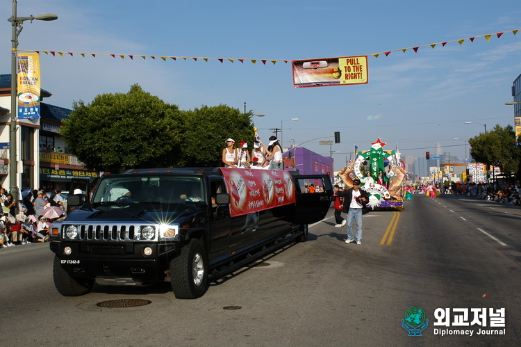 &nbsp;Women performers move on a front car leading the parade.